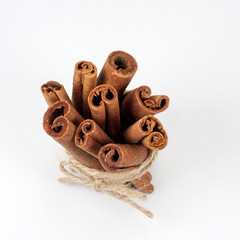 Tied bunch of cinnamon sticks isolated on white background