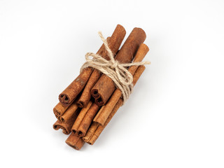 Tied bunch of cinnamon sticks isolated on white background