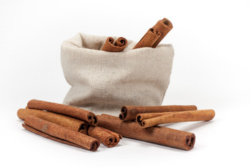 Bunch of cinnamon in canvas bag isolated on white background