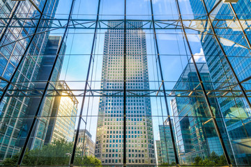 View of One Canada Square through glass window in Canary Wharf, London