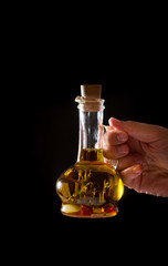 Bottle of olive oil with fresh herbs