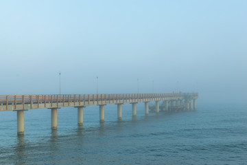 Fototapeta na wymiar Pier in the fog in Zelenogradsk on the Baltic sea