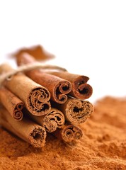 Cinnamon sticks and powder isolated background.