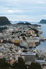 Naklejka premium Beautiful super wide-angle summer aerial view of Alesund, Norway, with skyline and scenery beyond the city, seen from the observation deck of Aksla mountain
