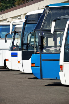Tourist buses at the bus station expect passengers, people travel and transportation concept