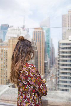 Rear View Of Woman Looking Through Glass Window At Restaurant