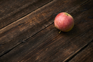 Apple on wooden boards background.