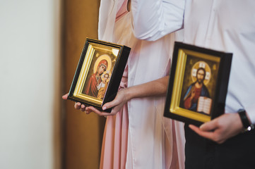 Young man and woman are holding icons 6523.
