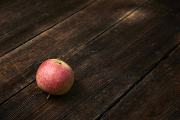 Apple on wooden boards background.