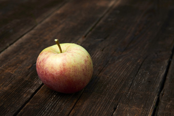 Apple on wooden boards background.