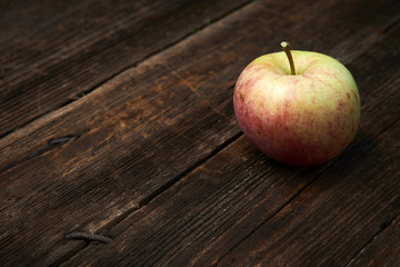 Apple on wooden boards background.