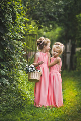 Little girls in pink dresses walking in the garden 6577.