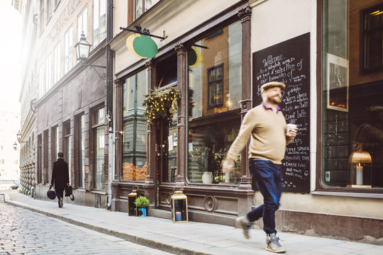 Sweden, Stockholm, Gamla Stan, Man walking by cafe