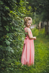 A childs portrait set amidst a blossomed garden 6659.