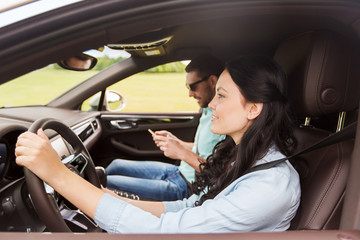 Fototapeta na wymiar happy man and woman driving in car
