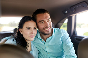 happy man and woman hugging in car