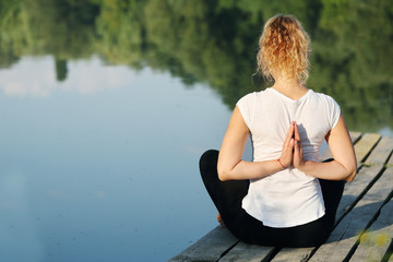 woman engaged in yoga, lotus