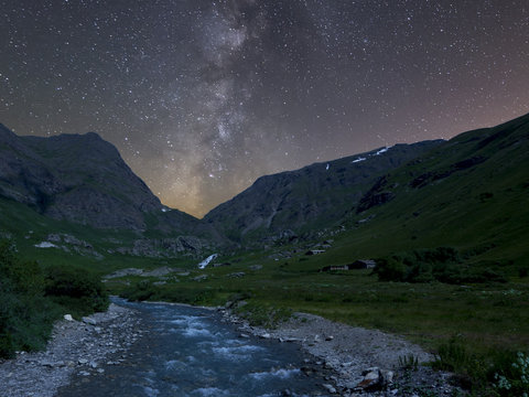 Night river and mountain landscape with milky way
