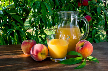 peach juice in a decanter and glass