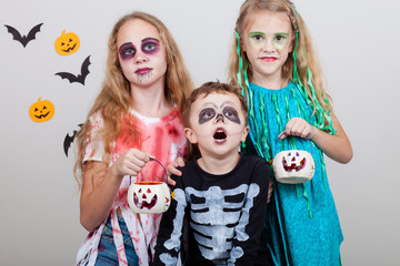 Happy brother and two sisters on Halloween party