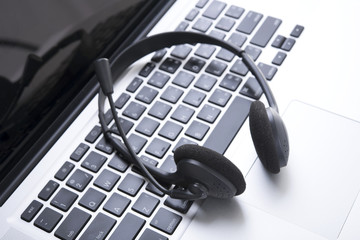 headset on keyboard computer laptop, call center support and customer service help, concept for communication
