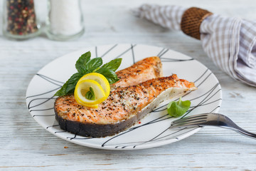 Grilled Salmon steak with lemon and herbs.