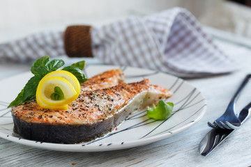 Grilled Salmon steak with lemon and herbs.