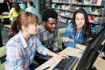 international students with computers at library