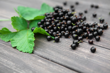 Black currants heap closeup on rustic wood background