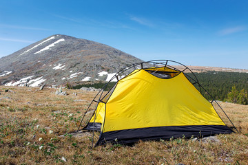 Camping with yellow tent on a sunny day