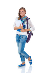 Portrait of a young student woman holding exercise books.