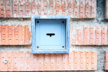 Close-up of garage key in brick wall