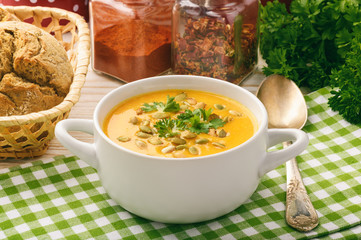 Vegetarian meal - cream carrot soup with pumpkin seeds. 