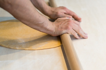 Preparing homemade pasta with rolling pin