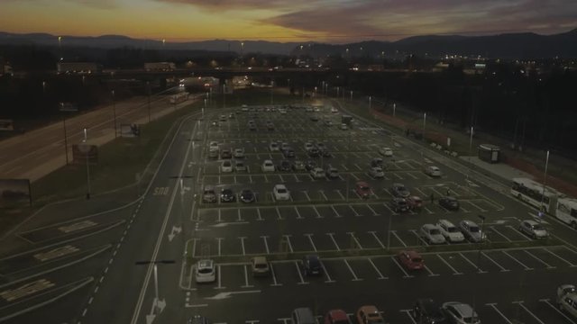 Aerial, tracking, passing at parking area, sunset, sunrise
