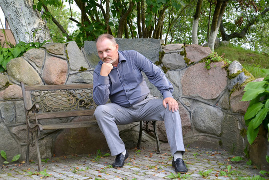 The Man Of Average Years Has A Rest On A Decorative Bench