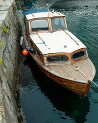 Fototapeta na wymiar Old wooden row boat on water in Norway