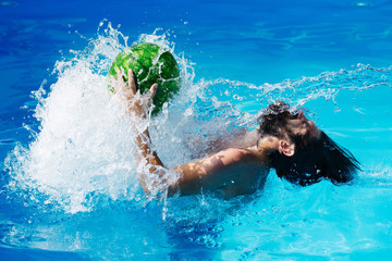 man with watermelon in swimming pool