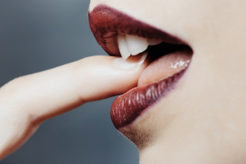 Female mouth with finger