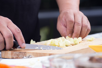 Chef is cutting baby corn