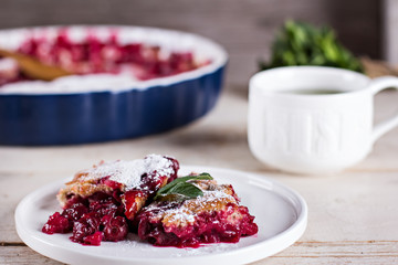 Cherry pie and a cup of tea. Rustic style. Berry pie. Homemade cherry pie with flaky crust, cup of coffee, bowl with cherries
