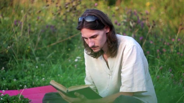 the guy reading a book in nature