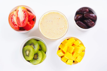 Top view of a healthy glass of mixed fruits smoothie on a white background.