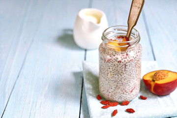 Chia seed pudding with peach and goji berri.