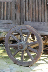 Fototapeta na wymiar Wooden wheel on the old cart.
