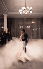 happy groom and his wife  dancing first dance in evening