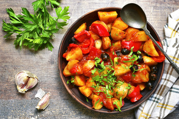 Mediterranean potato ragout with bell pepper and olives.Top view