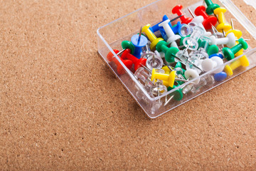 Group of thumbtacks pinned on corkboard