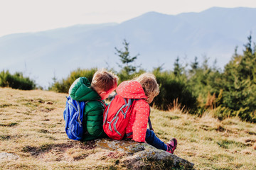 Fototapeta na wymiar little boy and girl travel in mountains