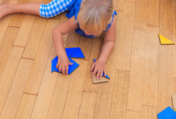 little girl playing with puzzle, early education